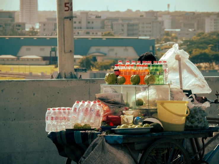 a covered outdoor table with drinks in a bag on top