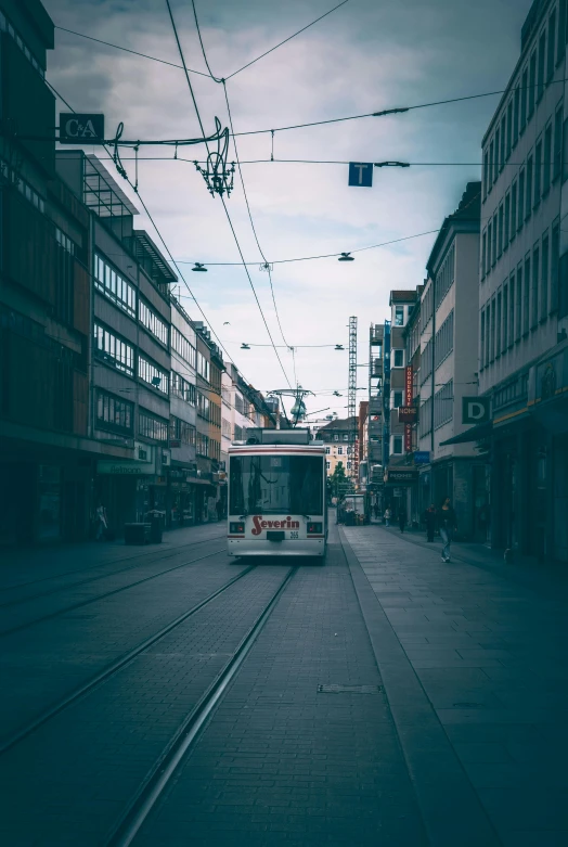 the bus is driving down the very old town street