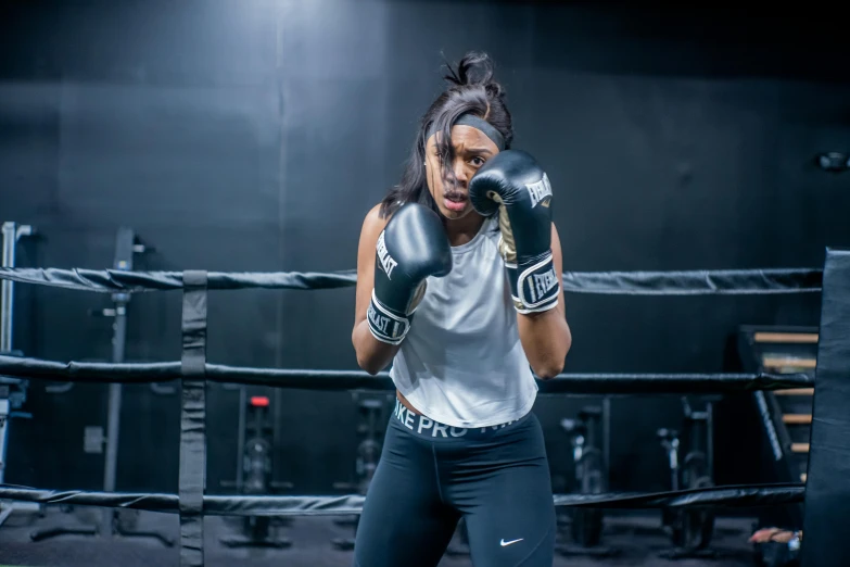 a woman in a boxing ring wearing boxing gloves