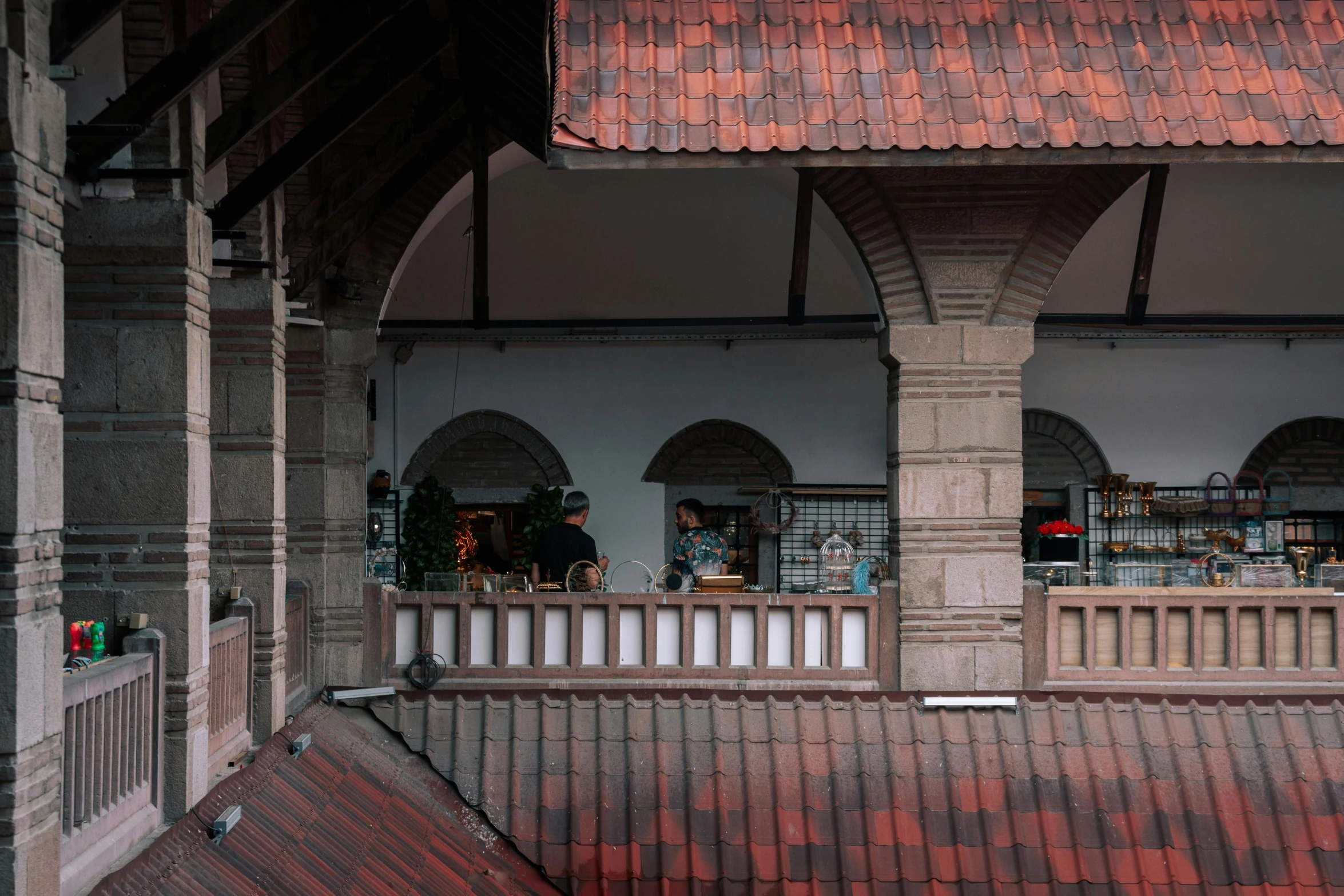 a brick roof covered in windows and a balcony area