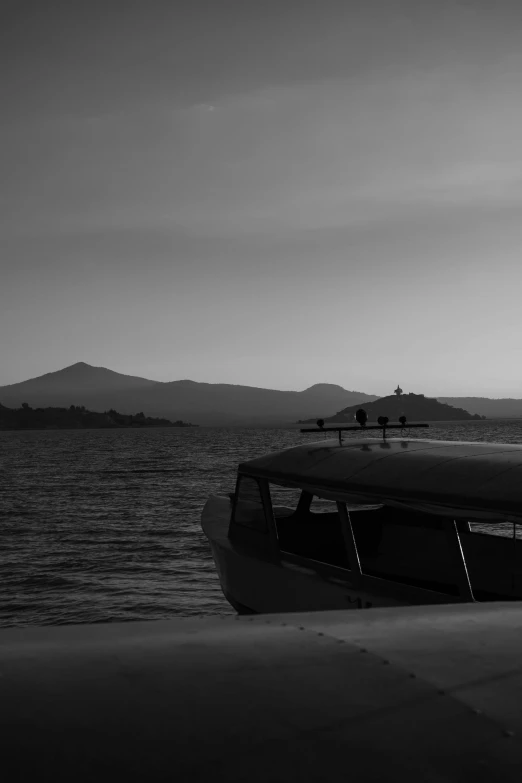 the boat is parked on the beach at sunrise