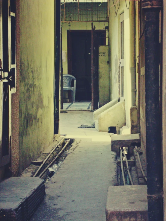 an open hallway leading to another room with an iron door