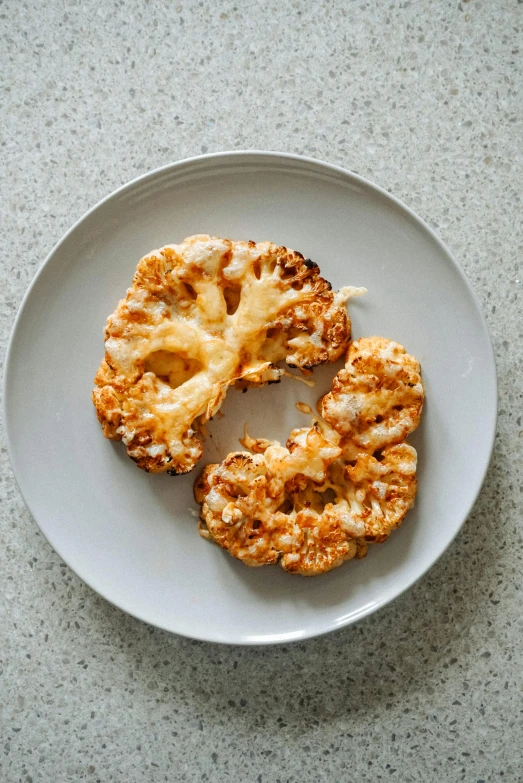 an ovened doughnut on a plate sits on a kitchen table