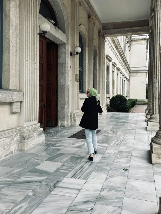 a woman walking through an inner city street