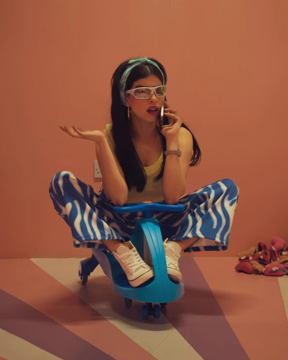 a woman sitting on a blue chair making a surprised face