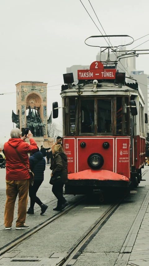 red trolley car on the streets in town