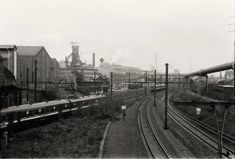 two trains traveling along side each other on train tracks