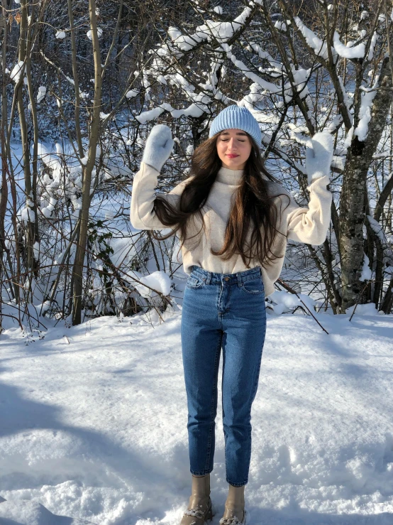 a person in the snow holding their hands up