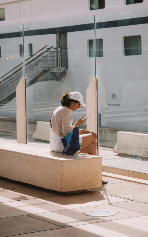 a woman is reading a book while sitting outside