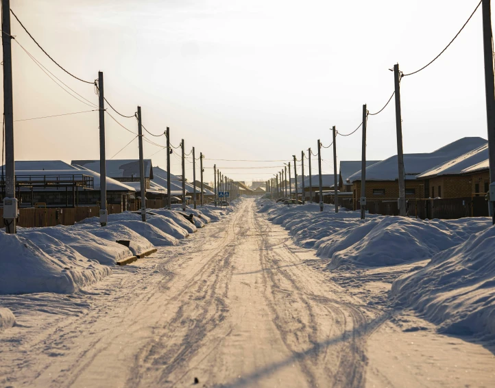 a road is covered in snow at a farm