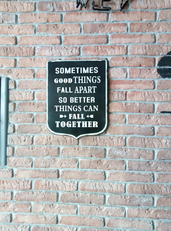 a brick wall with a sign that reads sometimes good things fall apart so better things can fall together