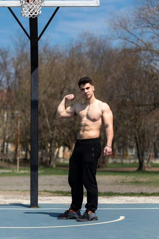 a man is on a court holding his arm up