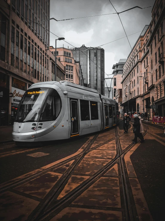 a high speed train traveling past tall buildings