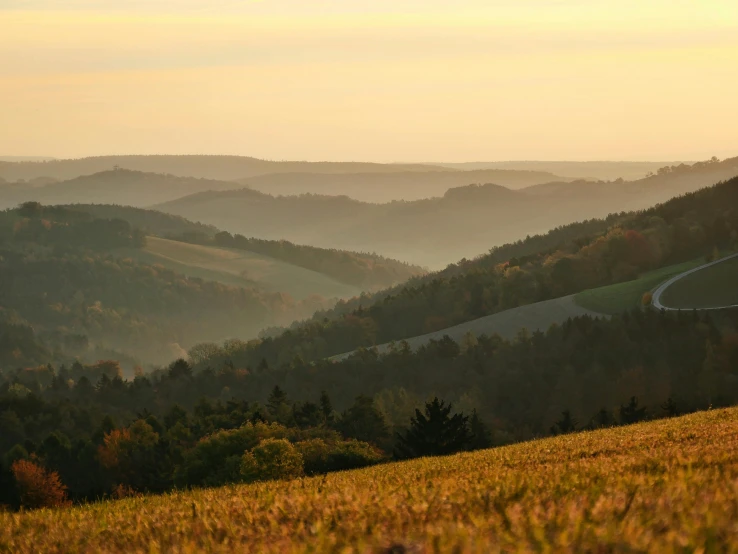 a view of the mountains in autumn with orange and yellow foliage