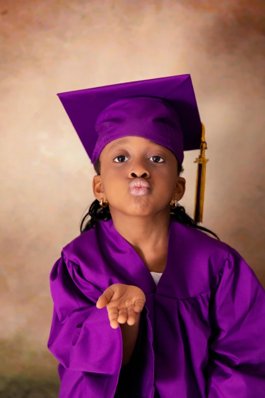 this is an adorable little girl in her cap and gown