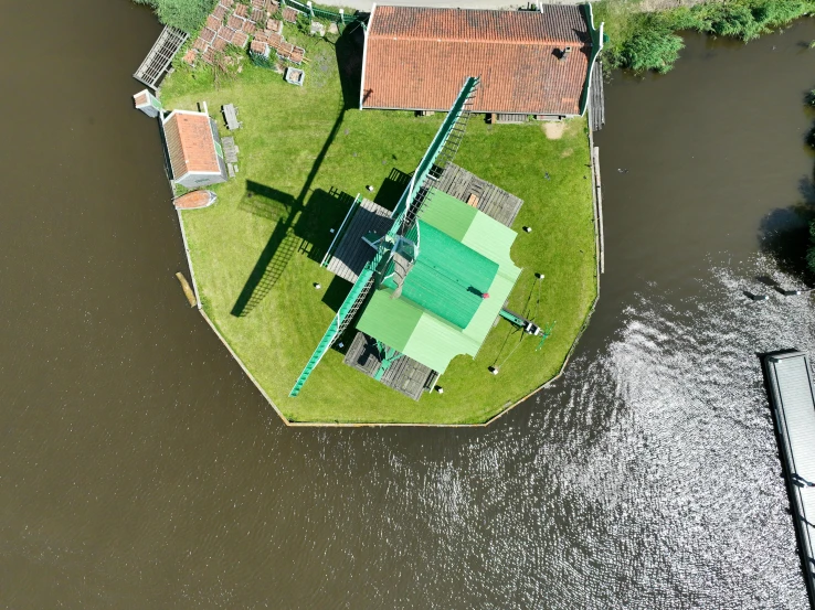 the top floor of an older home is almost submerged in a river