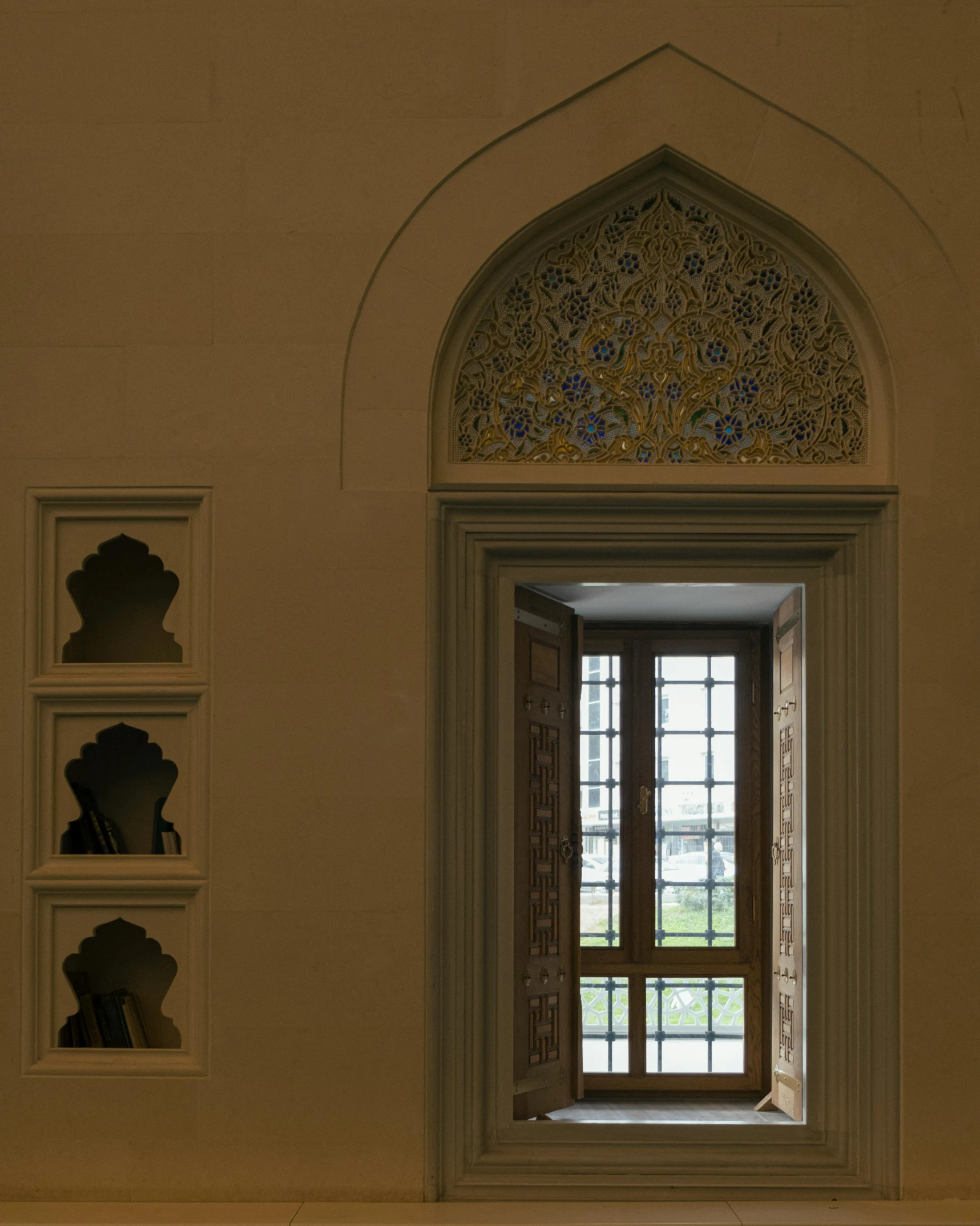 there is an ornate arch with three frames on the wall