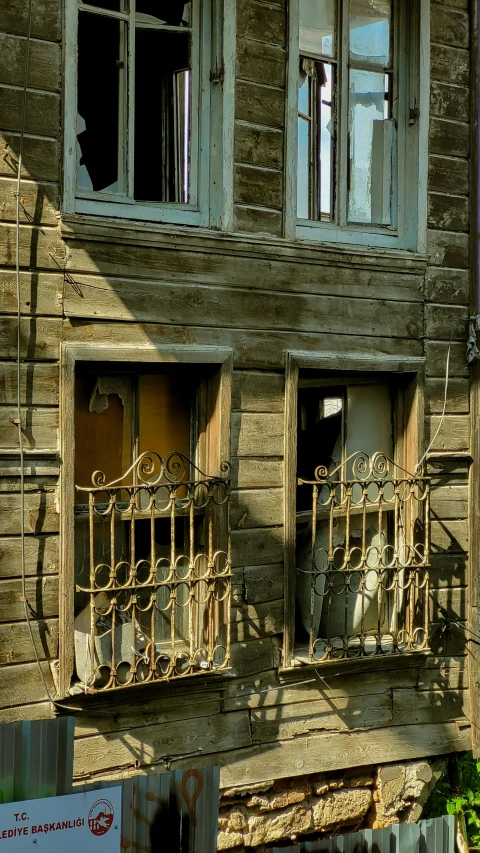 an old run down building with rusted windows