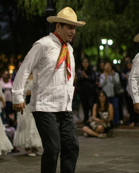 a man on a skate board is riding in front of a crowd