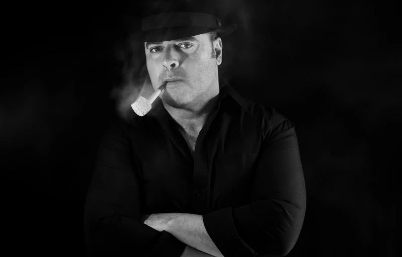 a man standing in smoke smoking a cigarette