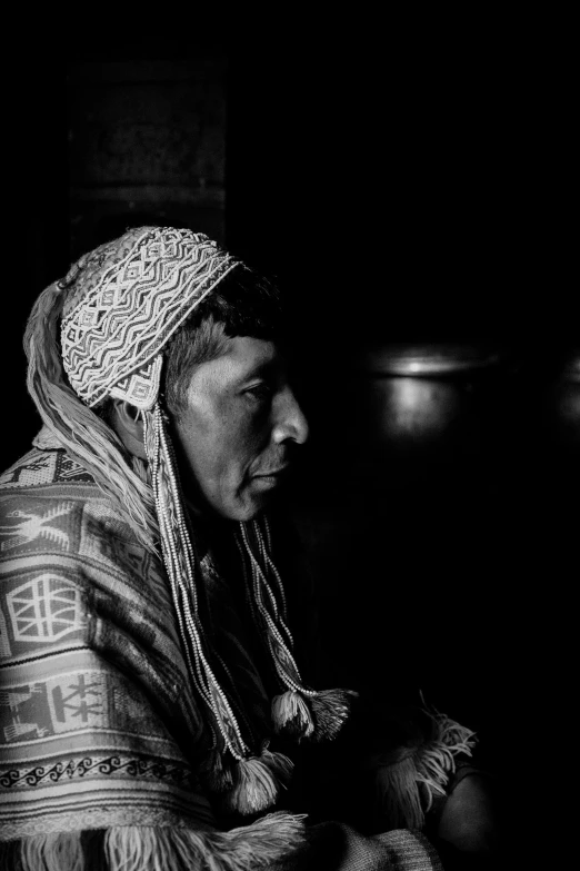 an indian woman sits in the dark