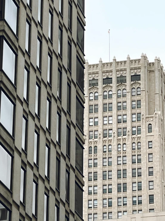 a tall white building sitting next to another large grey building