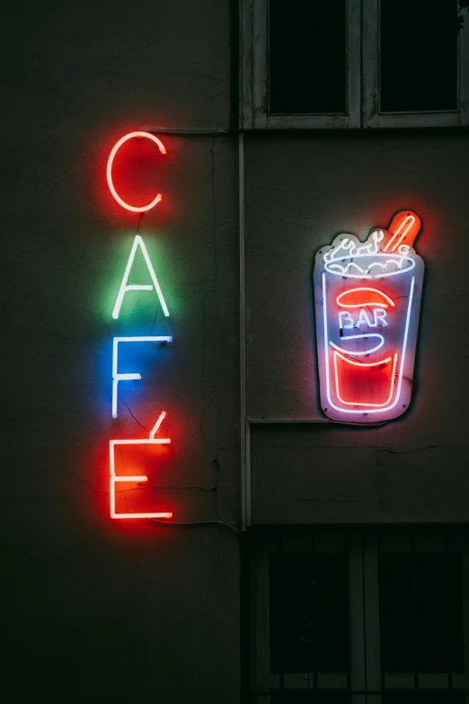 a neon sign that reads cafe eater next to a building