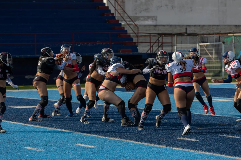 a group of girls in cheer uniform playing a game of soccer