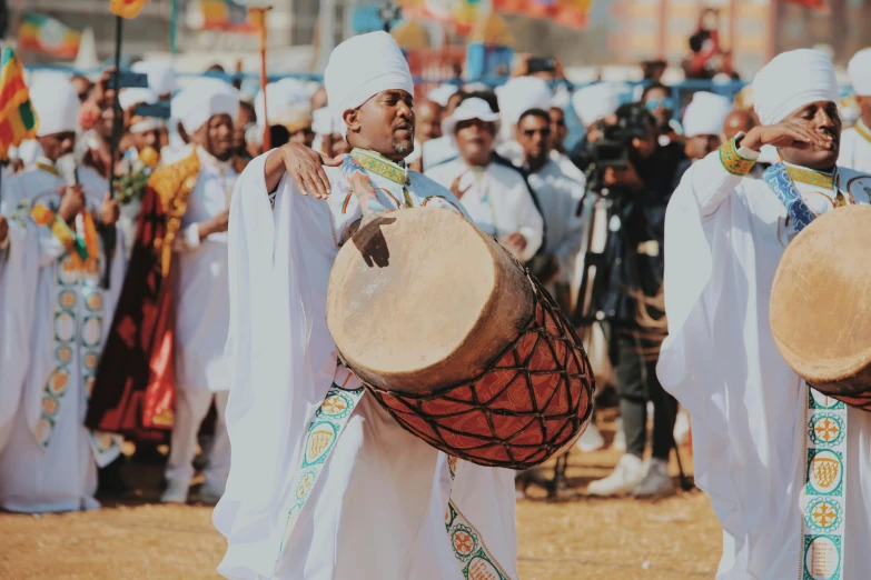 group of people in white costumes playing musical instruments