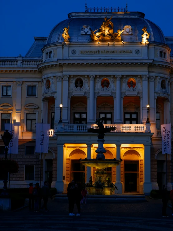 some people are standing outside a large building