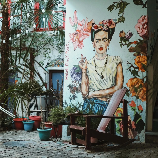 a mural of a man sits on the wall next to a woman in a flowered dress