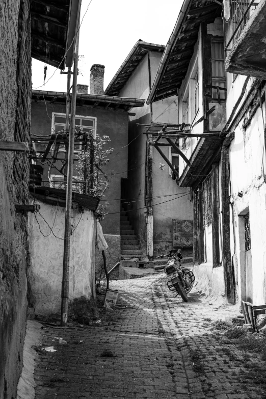 old cobblestone stone road and alley with rundown building