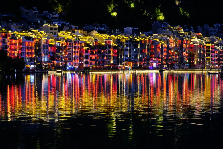 a row of bright buildings sits above the water