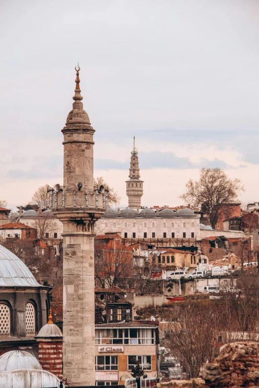 an old clock tower with towers in the city