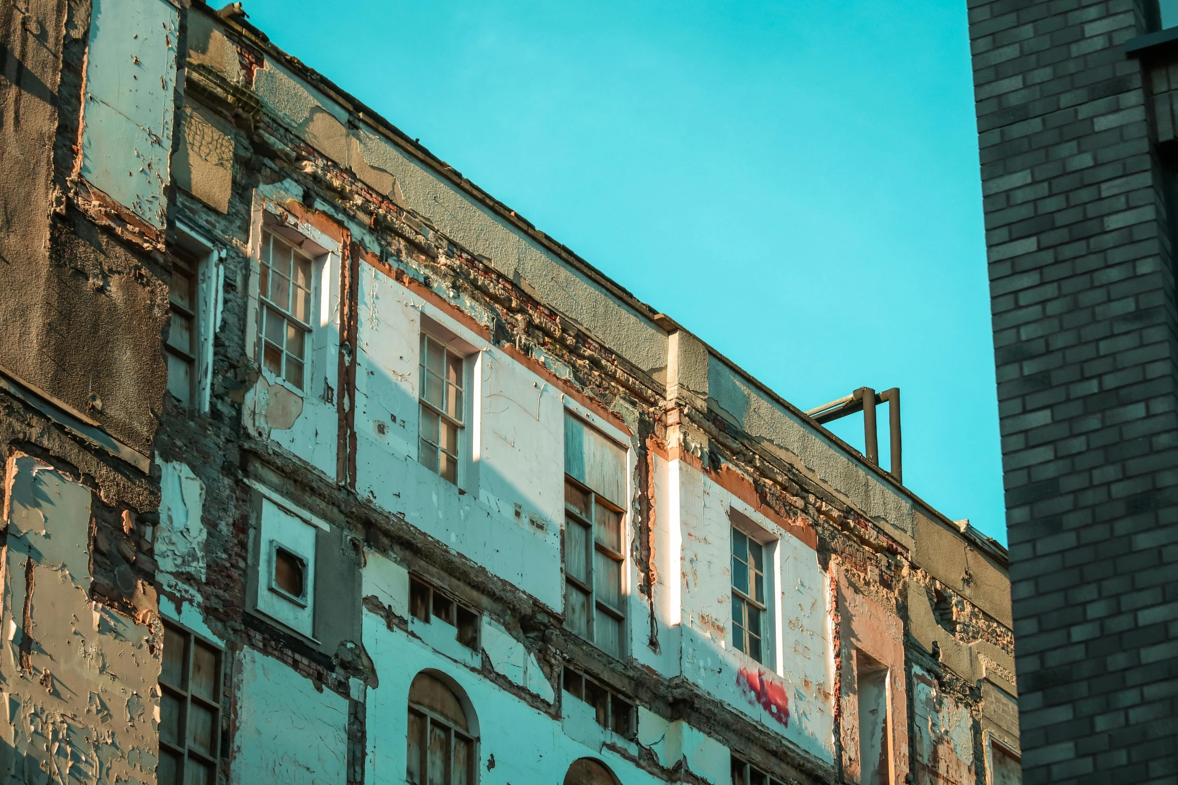 an old building with broken windows and crumbling walls