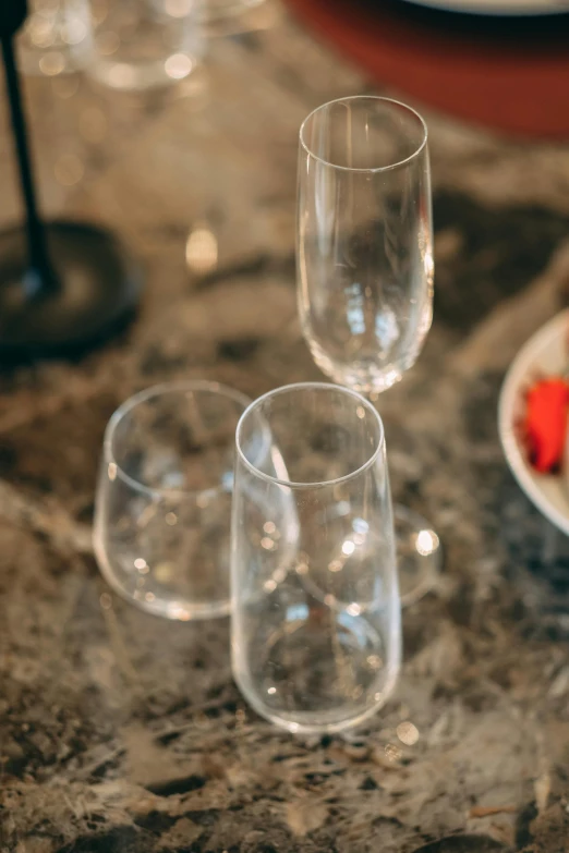 four empty wine glasses set on a table