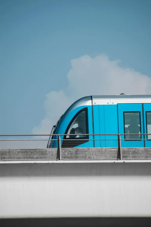 a train traveling over a bridge on a sunny day