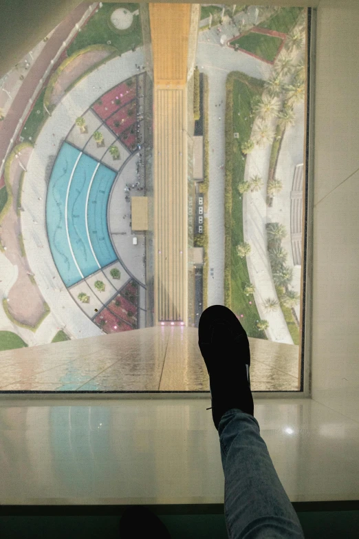 a hand is touching a large view of a city from inside the building