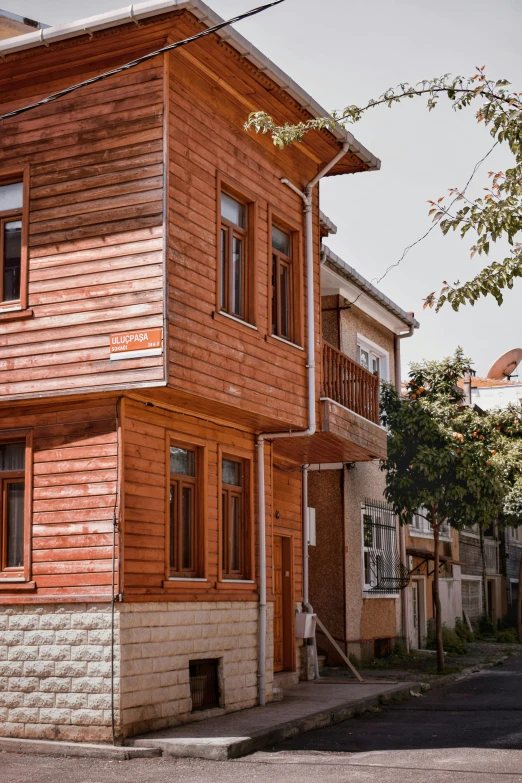 two large brown wooden buildings on the corner of the street