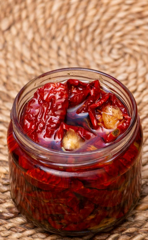 a jar filled with jelly and some other liquid on top of a table