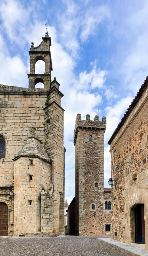 two very old buildings with towers built around them