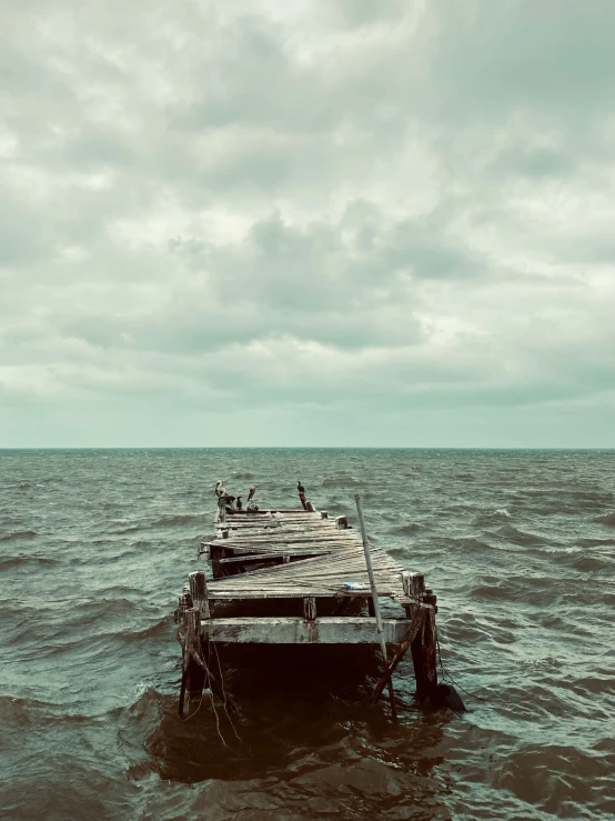 the wooden dock is in rough water