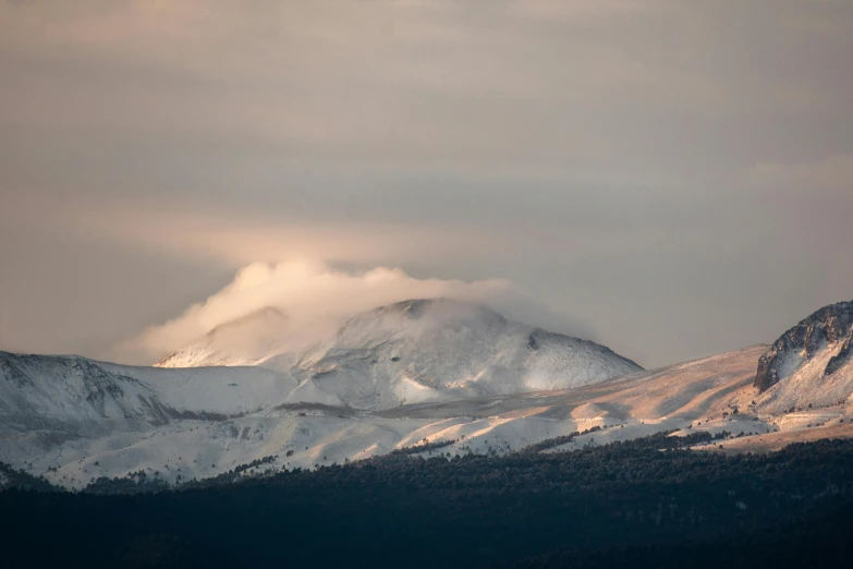 a snowy mountain range on a cloudy day