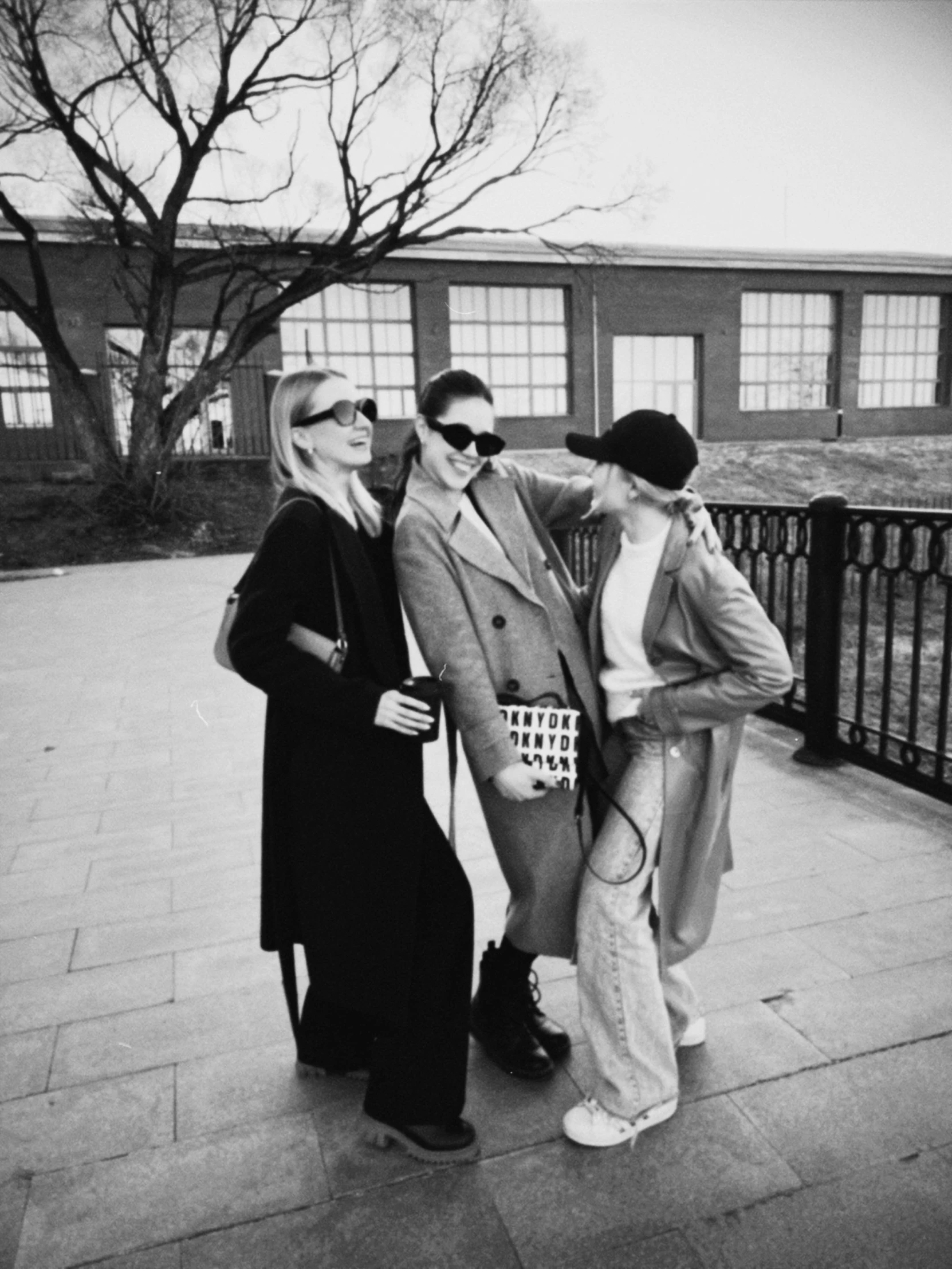 three women in black and white taking a picture together