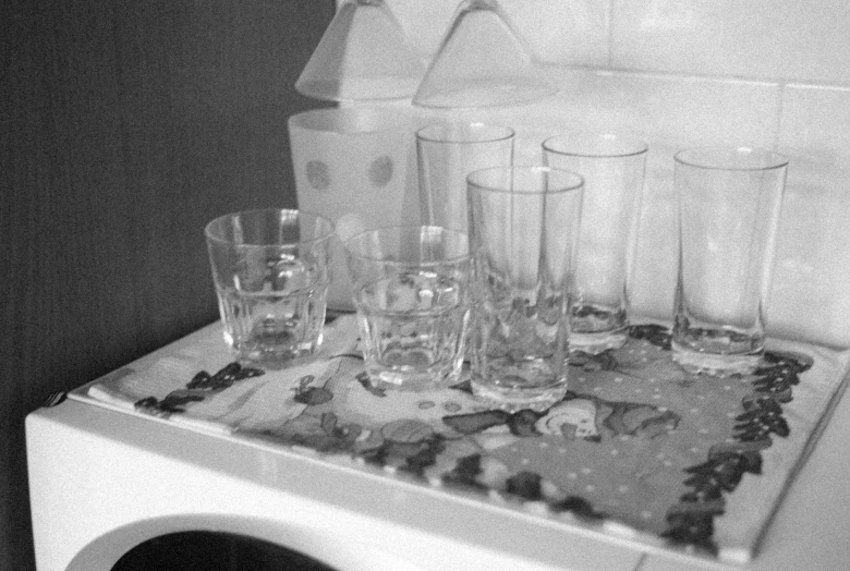 a bunch of s glasses sitting on top of an old fashioned washing machine