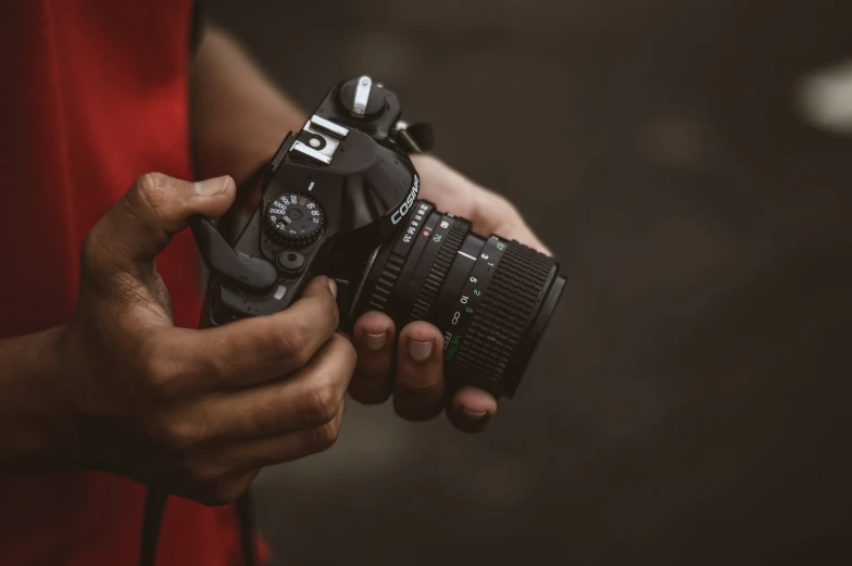 a person holding a camera with both hands