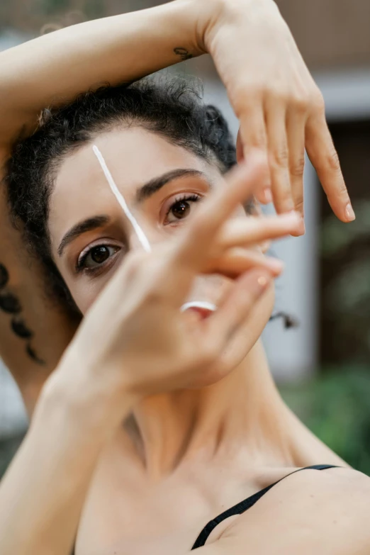 a woman with a black and white striped face makeup