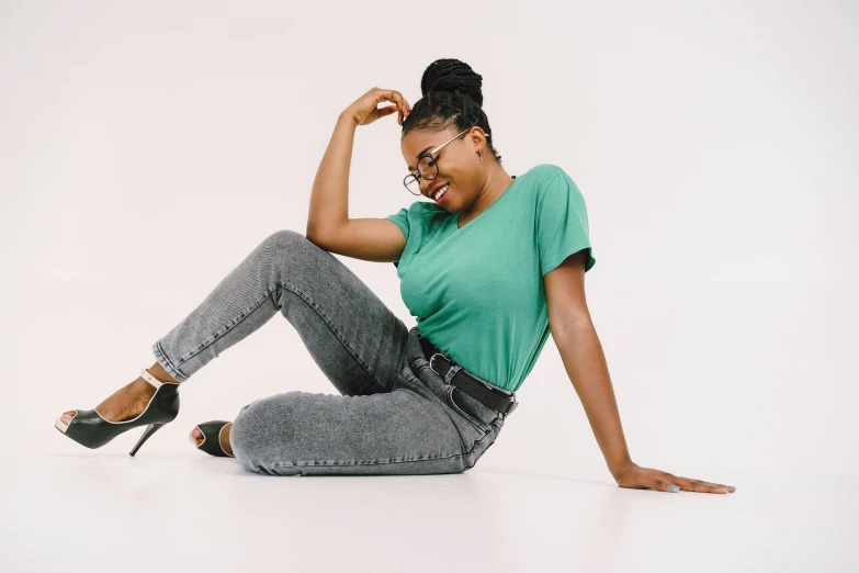 a young woman poses in the studio wearing her jeans