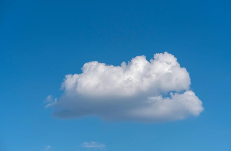 there are a few people riding horses near a cloud