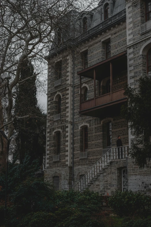 an old house with brick walls, and ornate balconies